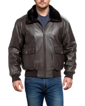 Man wearing a dark brown leather bomber jacket with a black fur collar, front zipper closure, flap pockets with buttons, and ribbed cuffs and hem, facing forward.