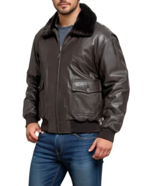 Side view of a man wearing a dark brown leather bomber jacket with a black fur collar, showing the jacket's arm fit, ribbed cuff, and partial view of the front pocket.