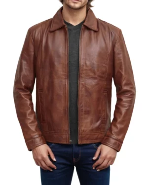 Men’s brown leather jacket unzipped over a dark tee — versatile layered look blending rugged charm and smart-casual fashion
