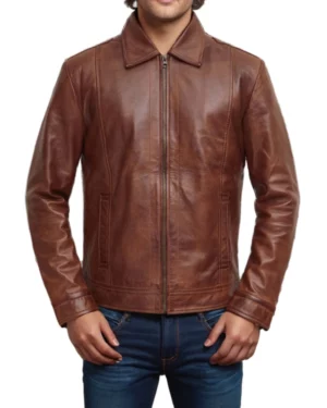 Men’s brown leather jacket front view — classic zip-up design with a sharp collar, clean lines, and rich cognac brown finish.