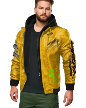 Male model wearing Cyberpunk 2077 Edgerunners David Martinez yellow bomber jacket with black hood, chrome arm patches, Cyberpunk branding on chest and sleeve, and green graffiti-style symbol near the hem.