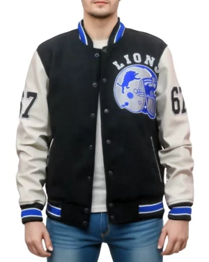 Man modeling a unbuttoned Detroit Lions varsity jacket, featuring a black body with cream sleeves, and detailed Lions team graphics prominently displayed on the chest.